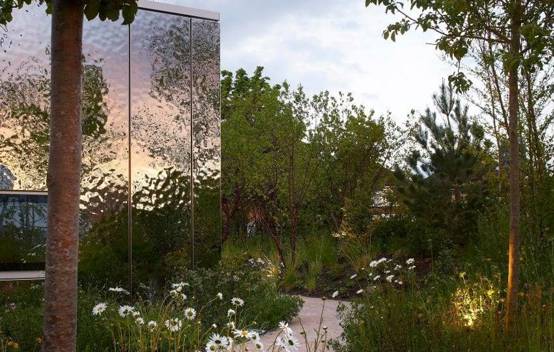 Close-up of the bespoke ceramics at Maggie’s Southampton, showing the ethereal reflection of the New Forest landscape on the ceramic blockwork