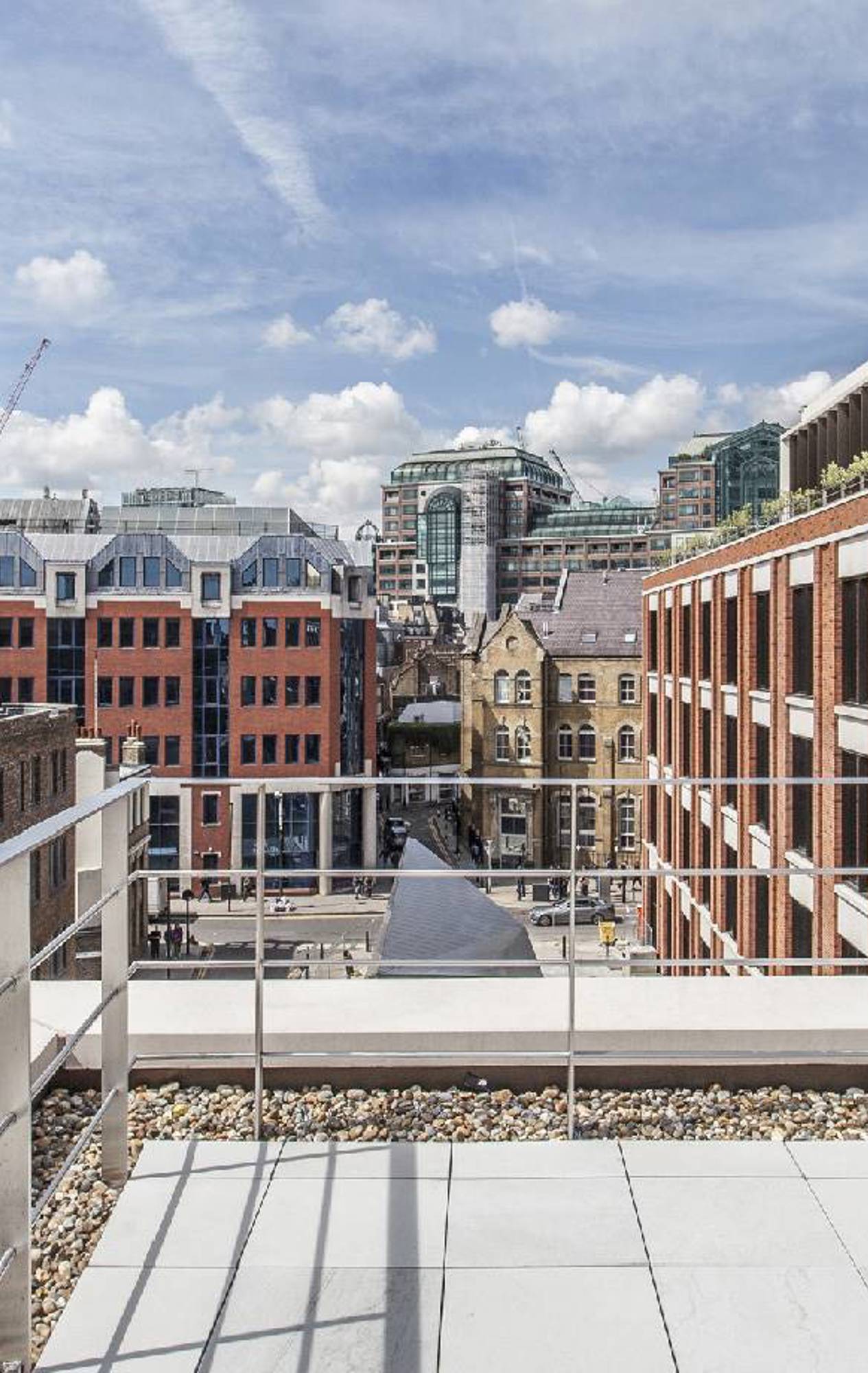 Detailed view of where the glass panels meet the steel framework on the facade of the London Fruit & Wool Exchange