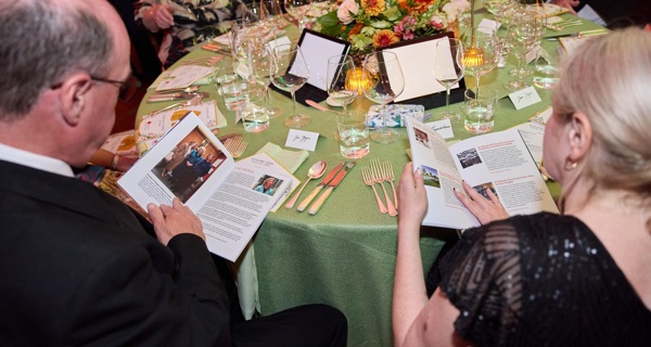Guests flick through programme