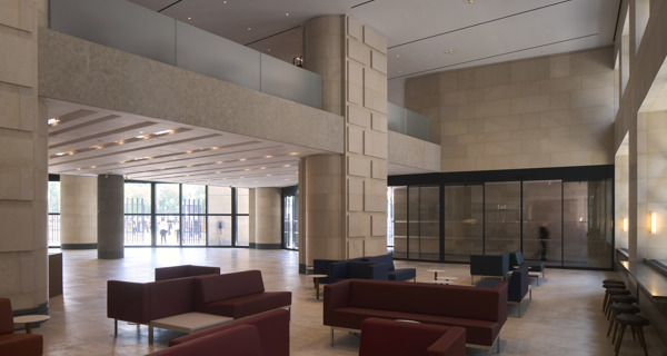 A spacious gallery room with high ceilings, and natural light filtering through skylights.