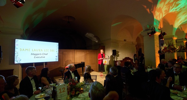 Dame Laura Lee addresses the room